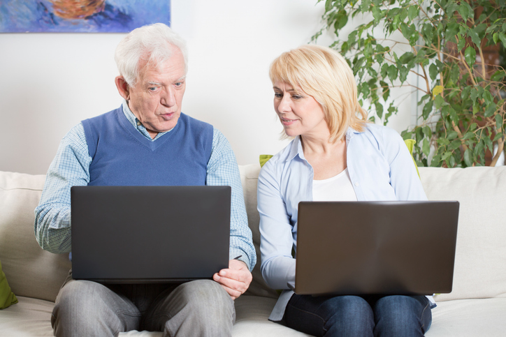 A senior couple comparing their retirement plans.