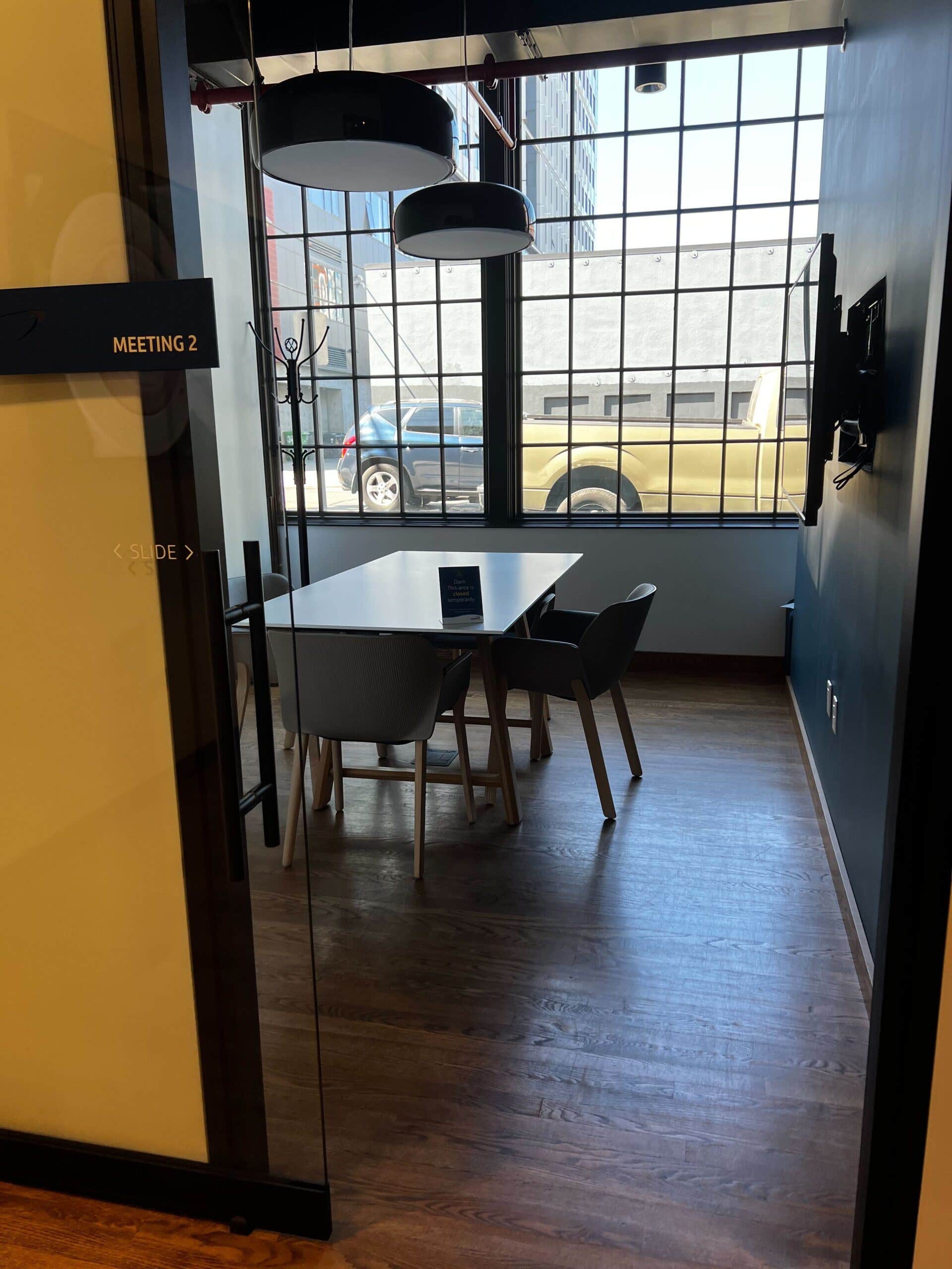 Cafe meeting room equipped with screens and meeting table