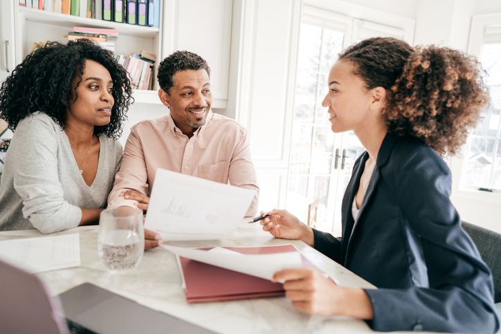 A couple working with a financial advisor to manage their retirement accounts.